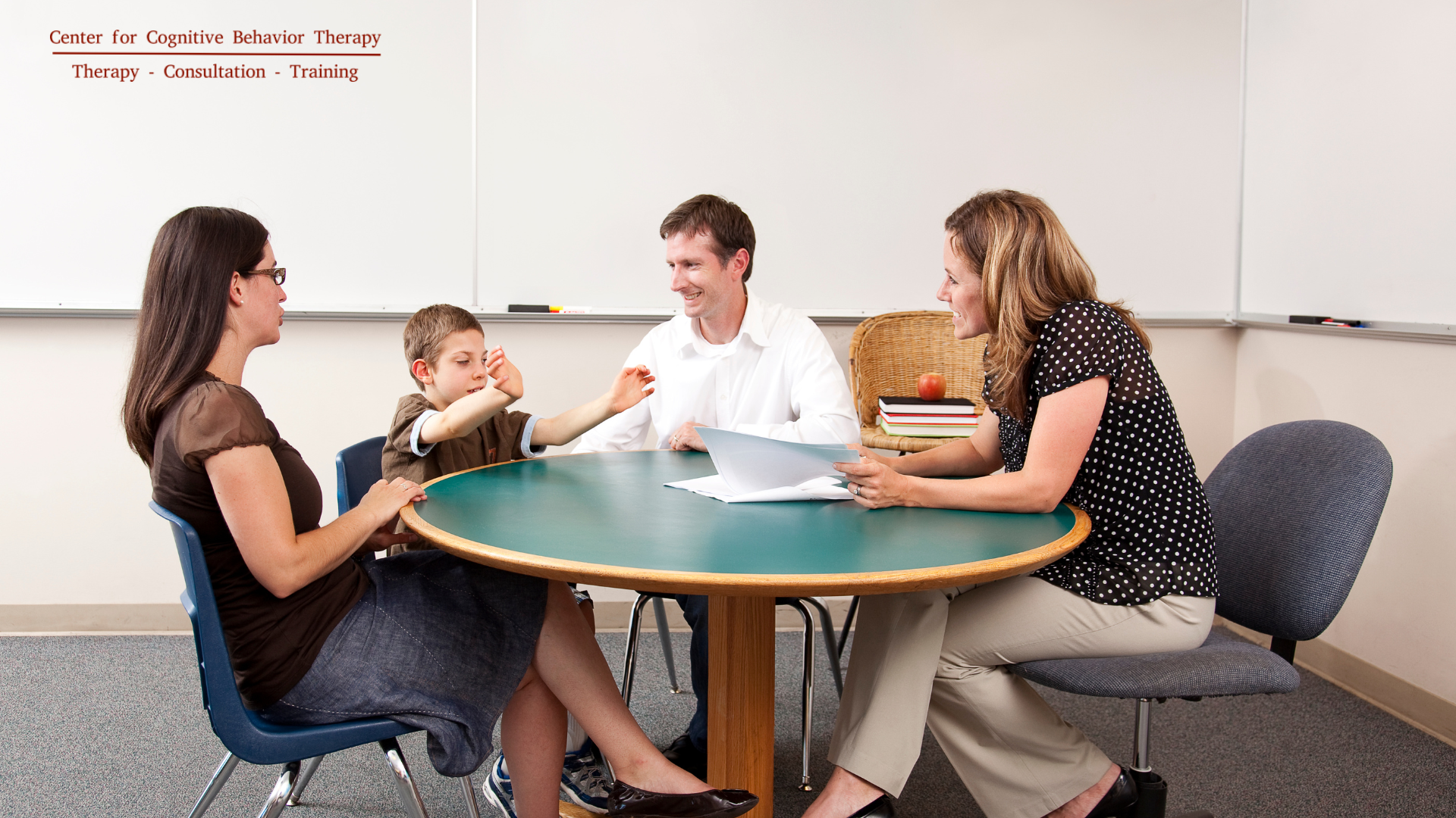 A parent and teacher engaged in a serious discussion during a parent-teacher conference, collaboratively working to enhance the child's educational experience.