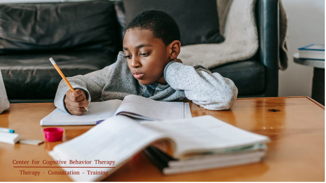 A focused child diligently working on homework assignments, showcasing the importance of reviewing academic progress and understanding their educational needs.