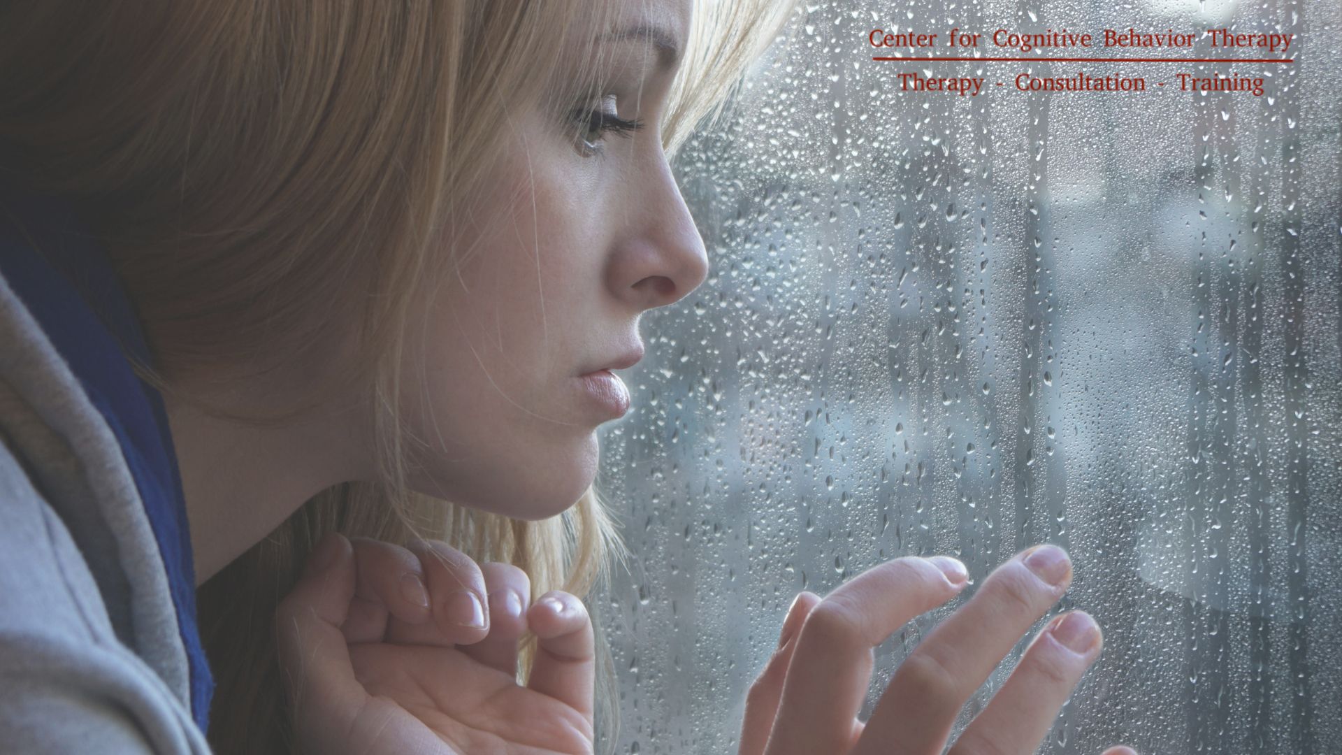 A serene individual practicing Radical Acceptance in DBT, sitting contemplatively by a window while observing the rain, embodying tranquility amidst life's challenges.