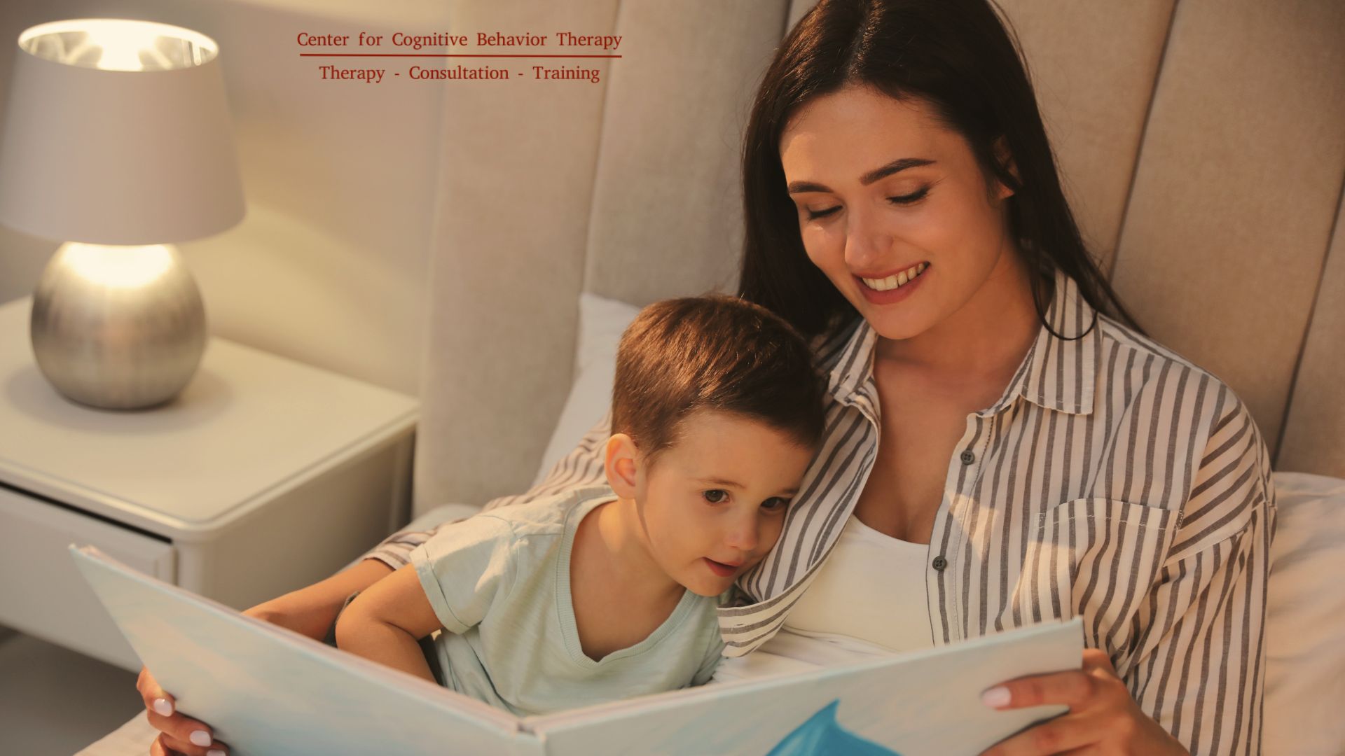 Photograph showing a parent and child cuddled up together, reading a book before bedtime, illustrating the bonding and relaxation aspect of the bedtime routine.